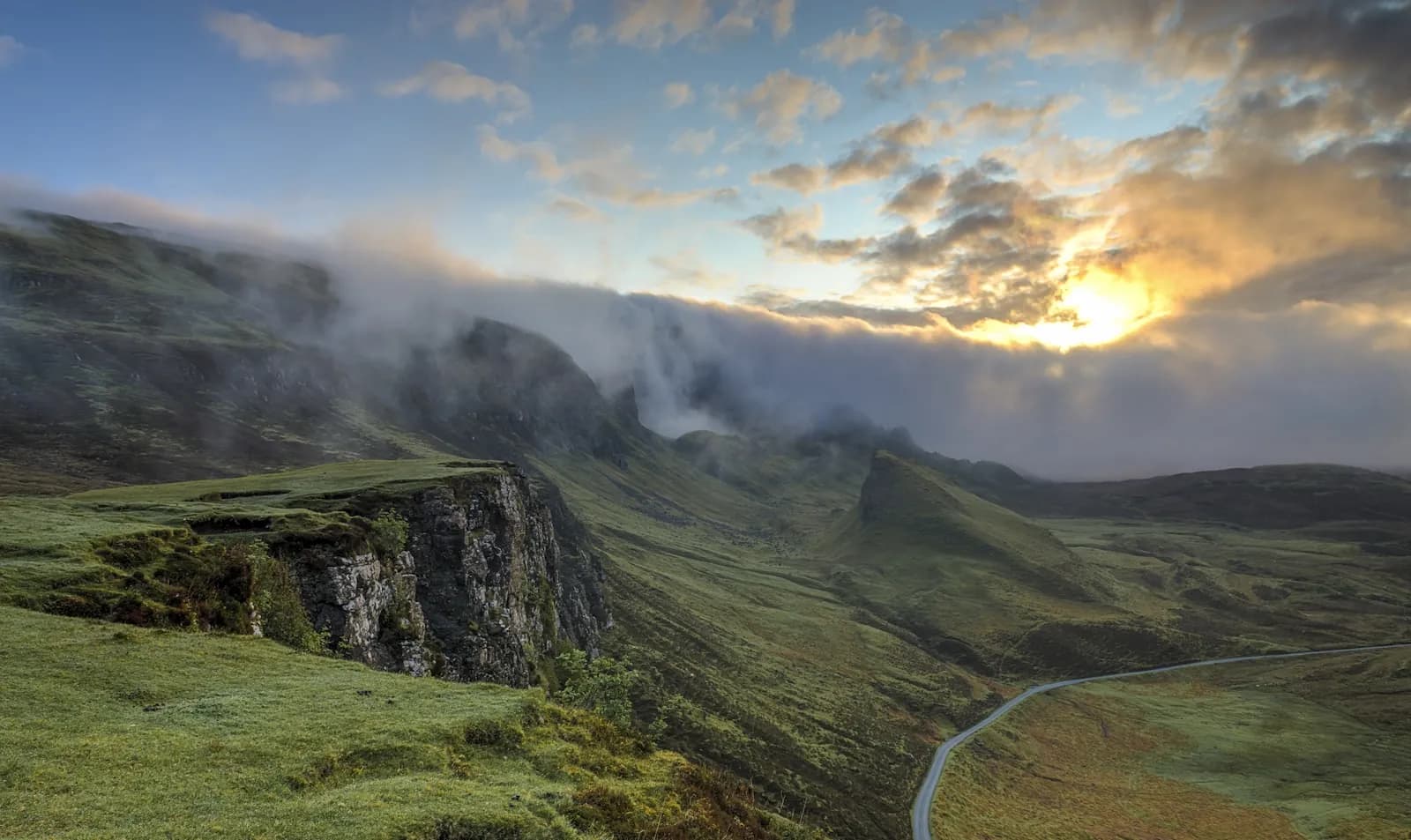 Low clouds and a weather front over a mountain landscape